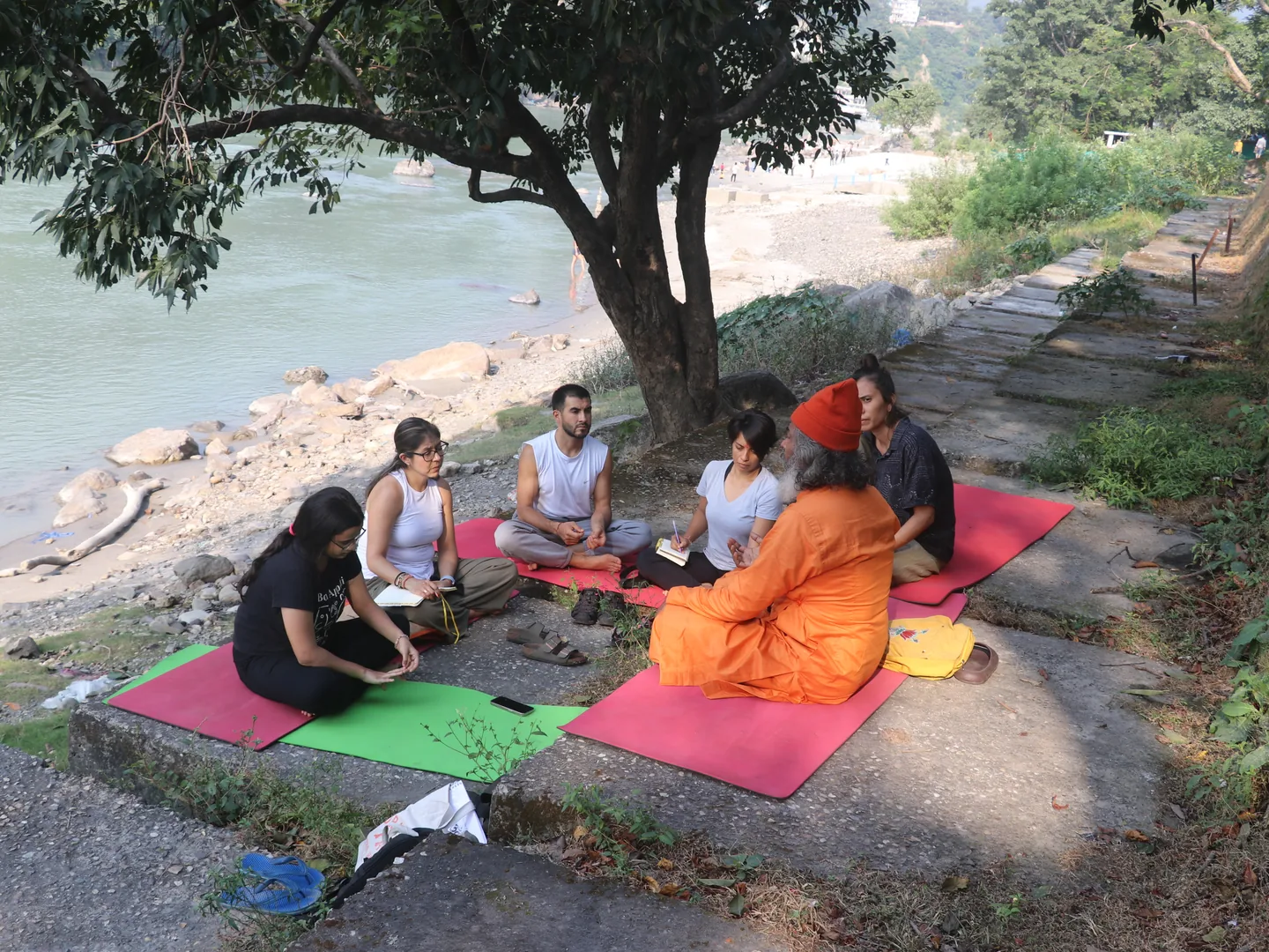 Students meditating beside the Ganga River in Rishikesh, India