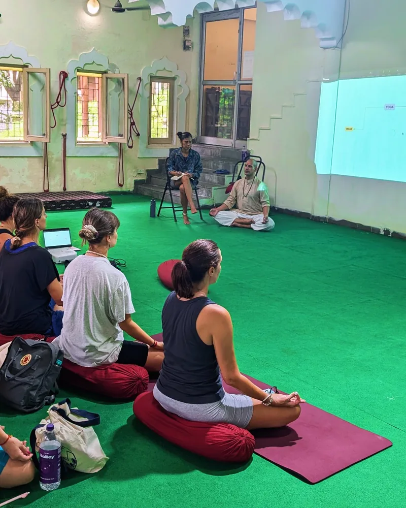 Teacher leading a yoga philosophy class at the academy