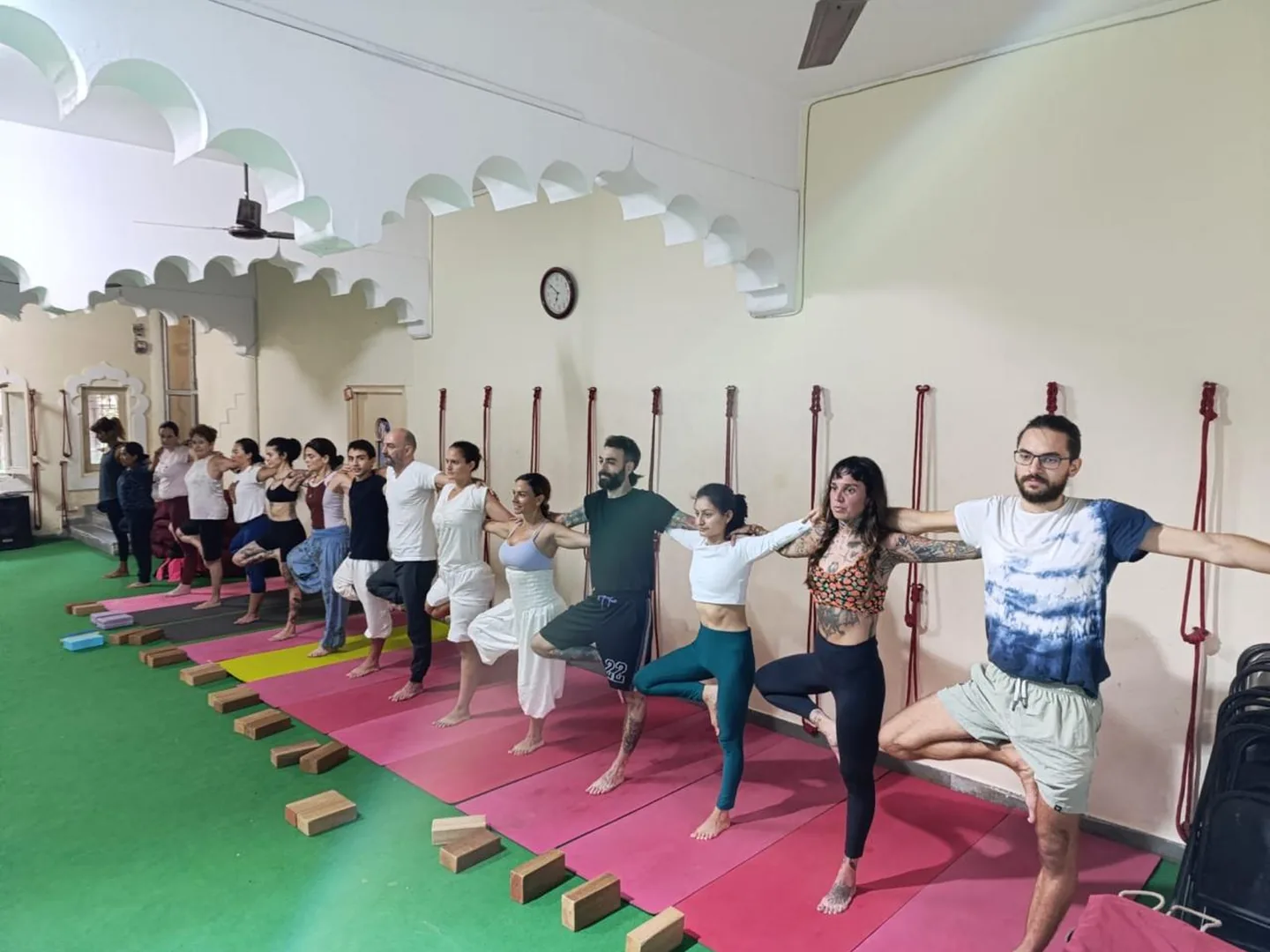 Yoga teacher training students practising asana together in Rishikesh